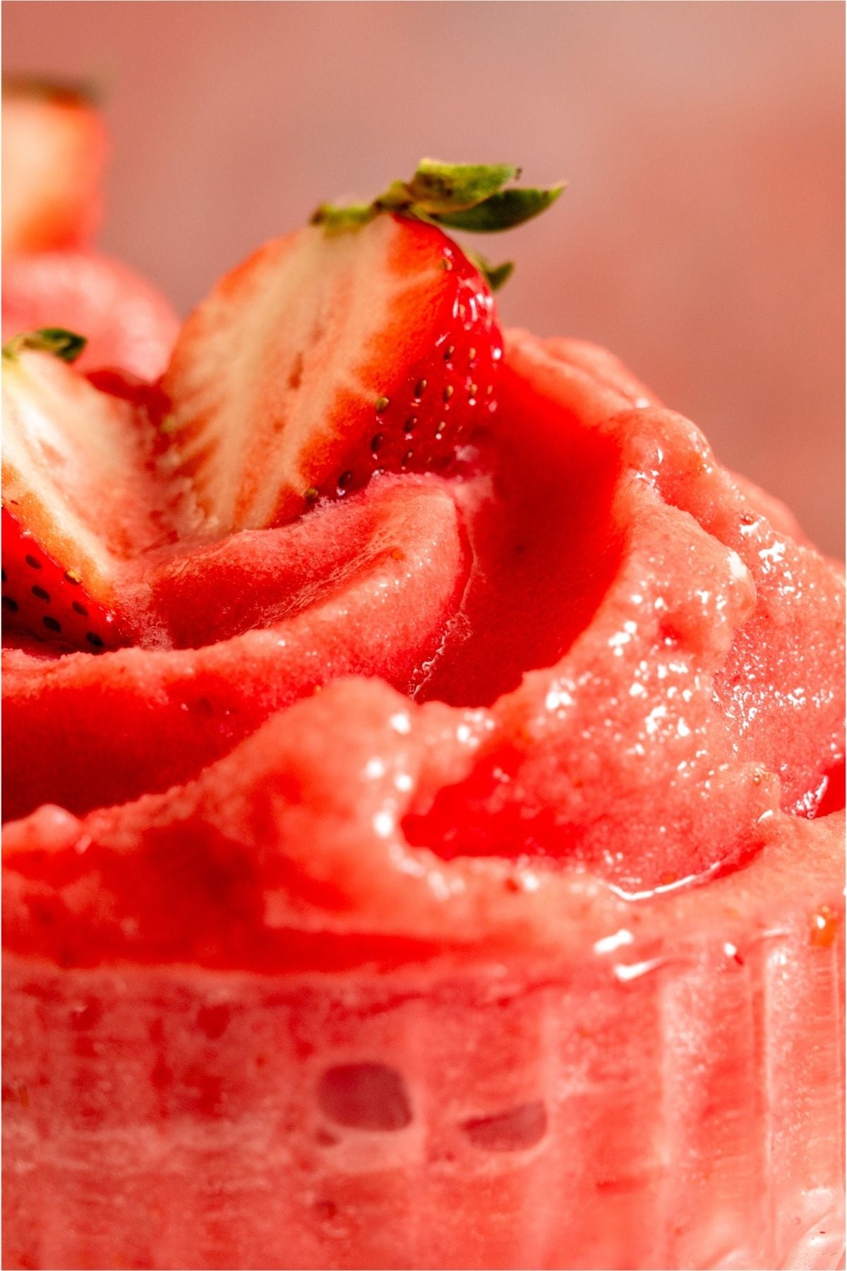 Close up of a Strawberry Dole Whip in a glass.
