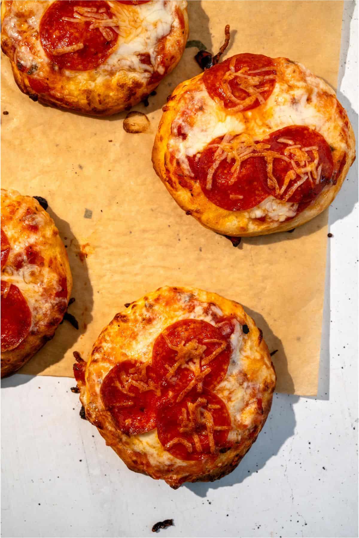 Air Fryer Pizzas on top of parchment paper