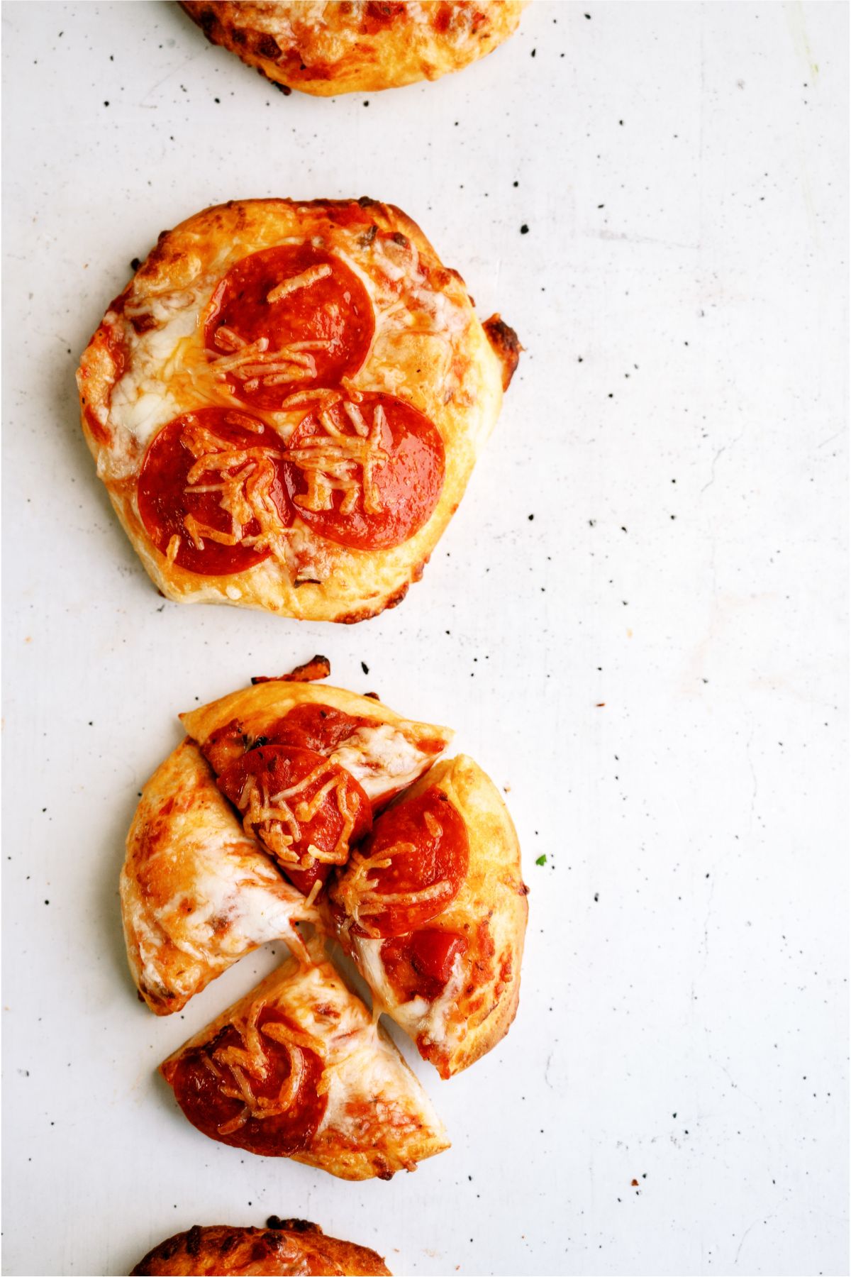 Air Fryer Pizzas with one cut into triangles