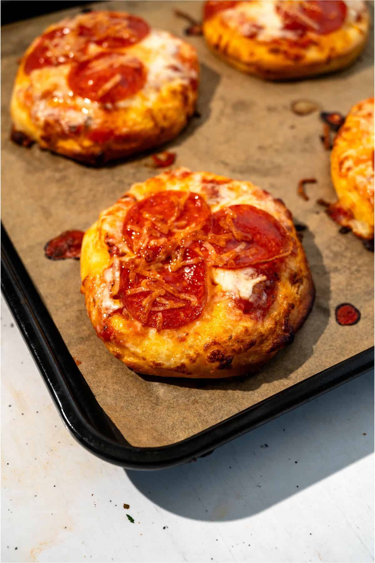 Air Fryer Pizzas on top of parchment paper