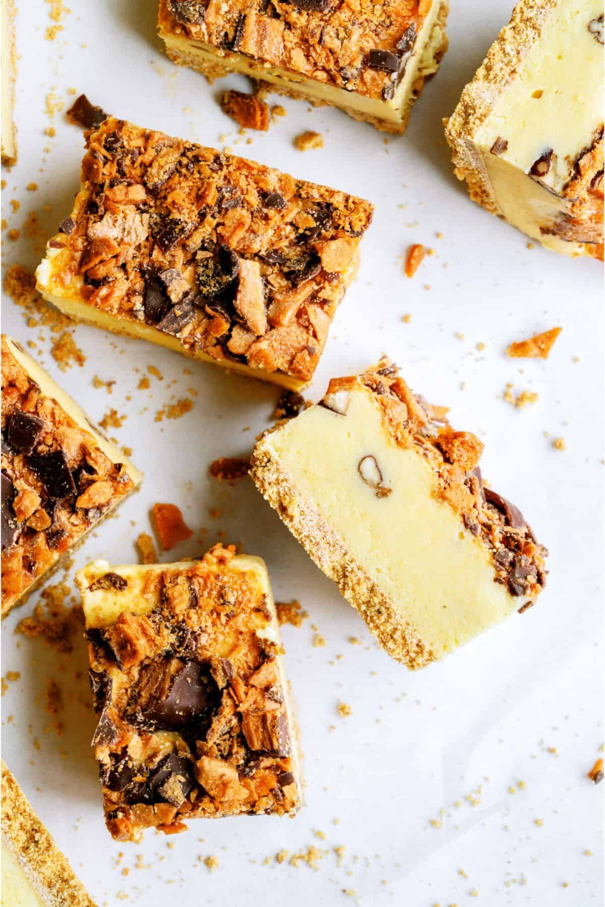 Butterfinger Ice Cream Bars cut into squares with one on the side to show the inside of the bar.