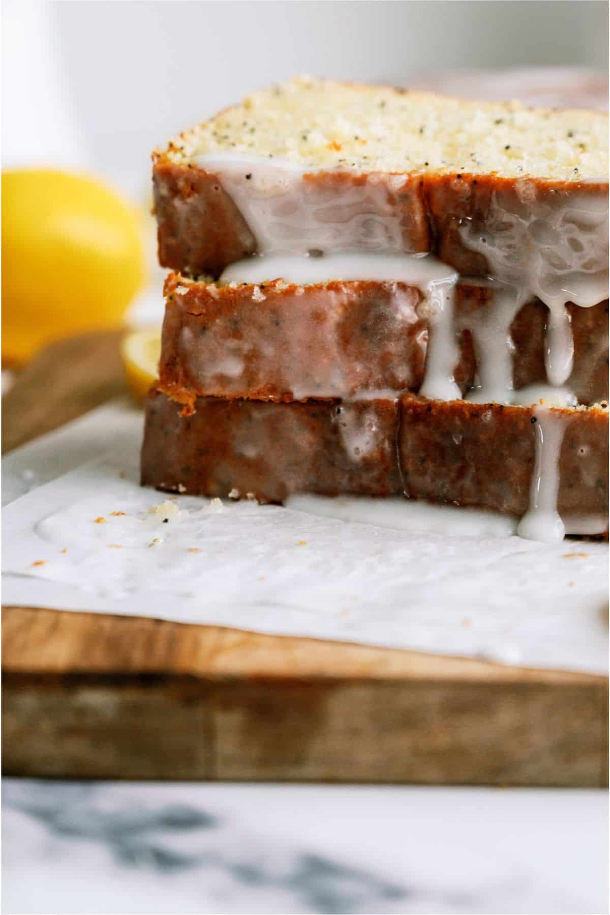 Glazed Almond Poppy Seed Bread slices with glaze