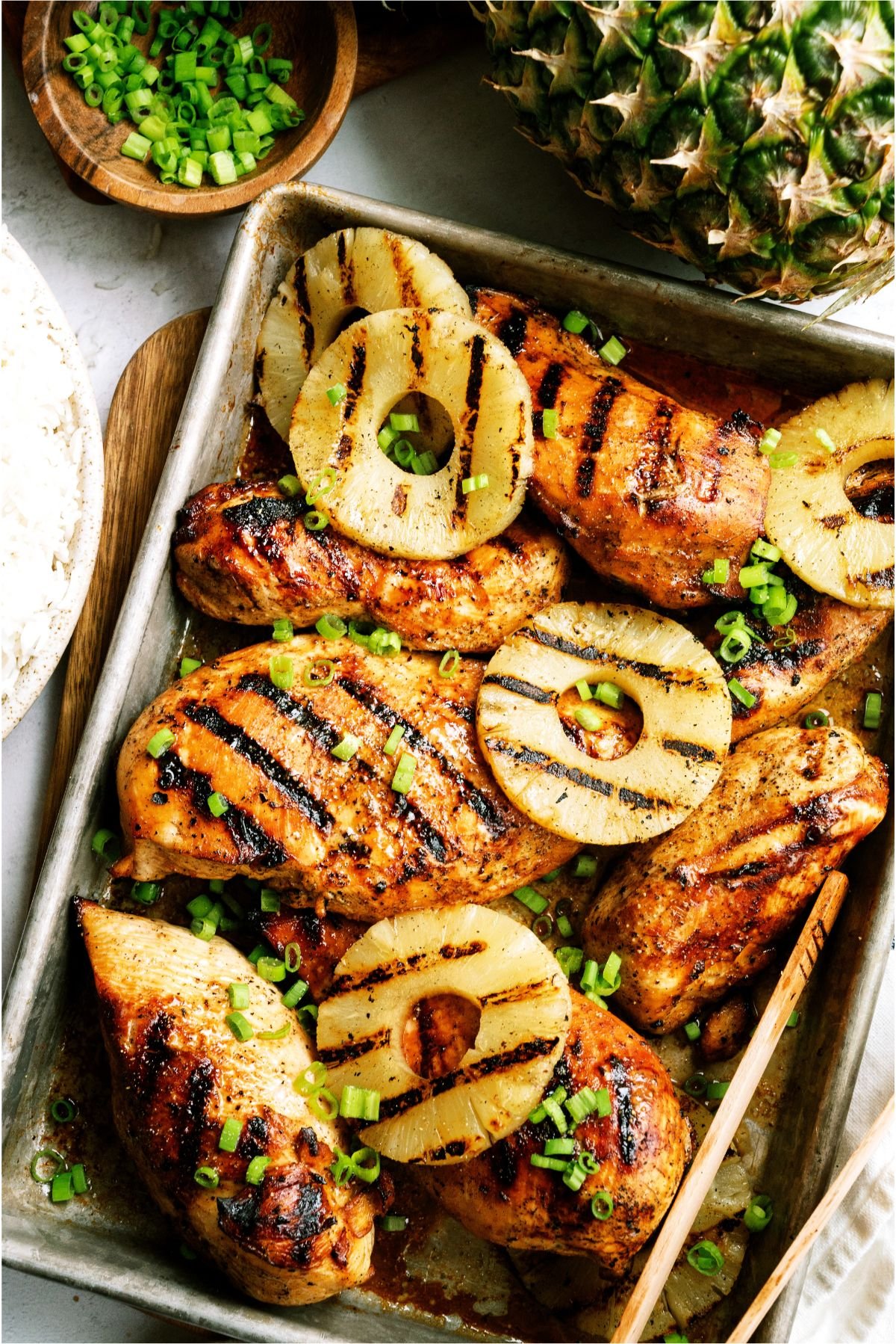 A sheet pan filled with Grilled Pineapple Teriyaki Chicken and Grilled Pineapple
