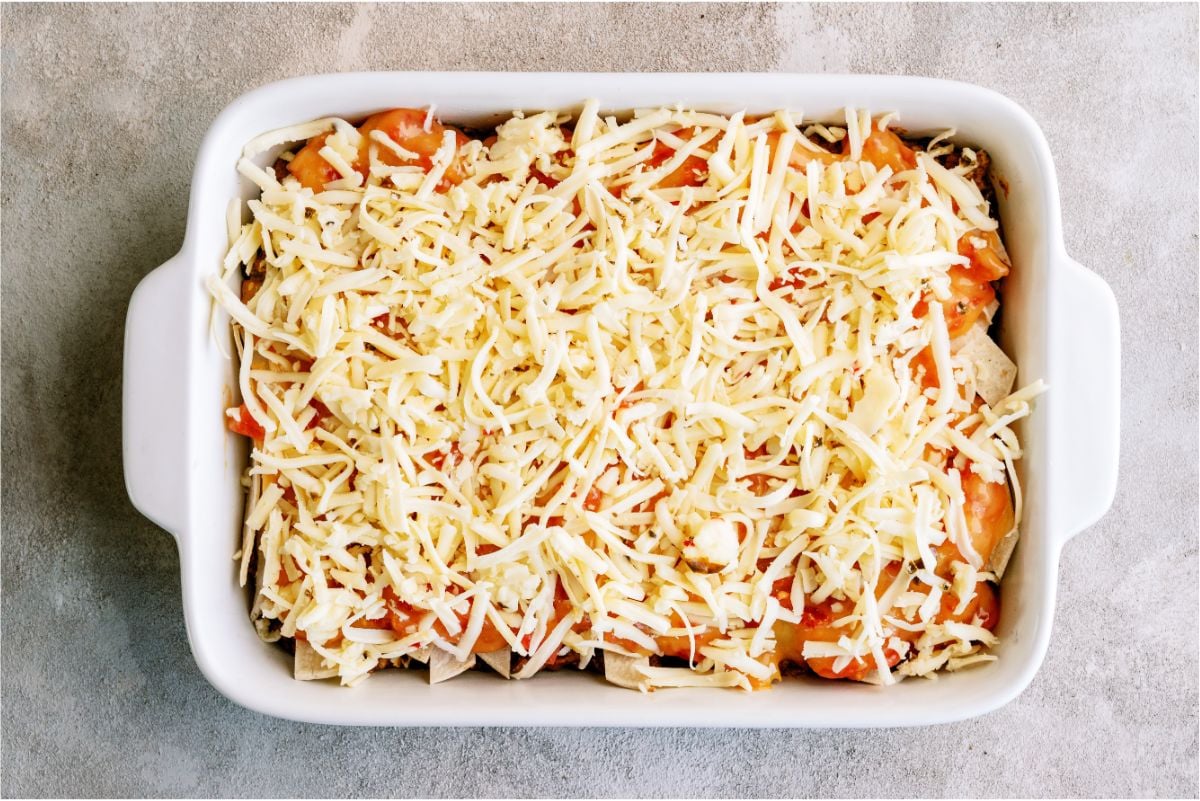 Shredded pepper jack cheese layered on top of casserole