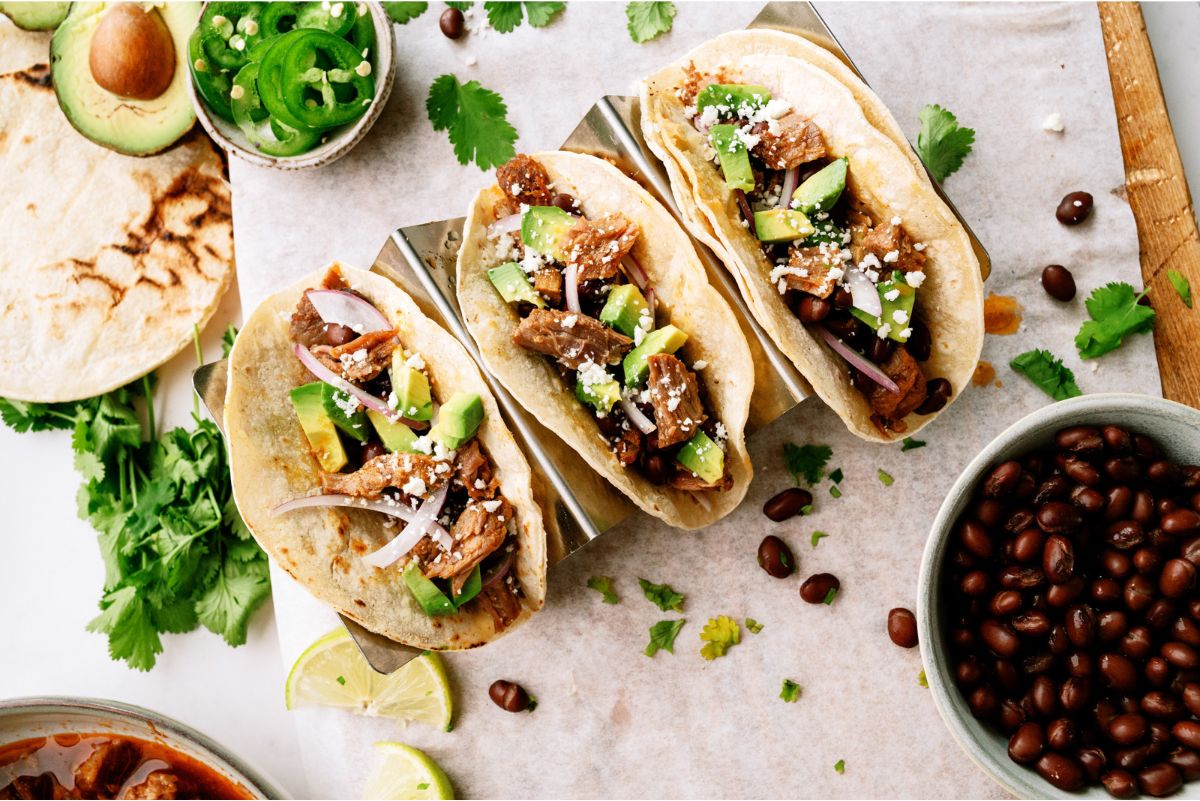 Top view of 3 Instant Pot Honey Chipotle Pork Tacos with toppings
