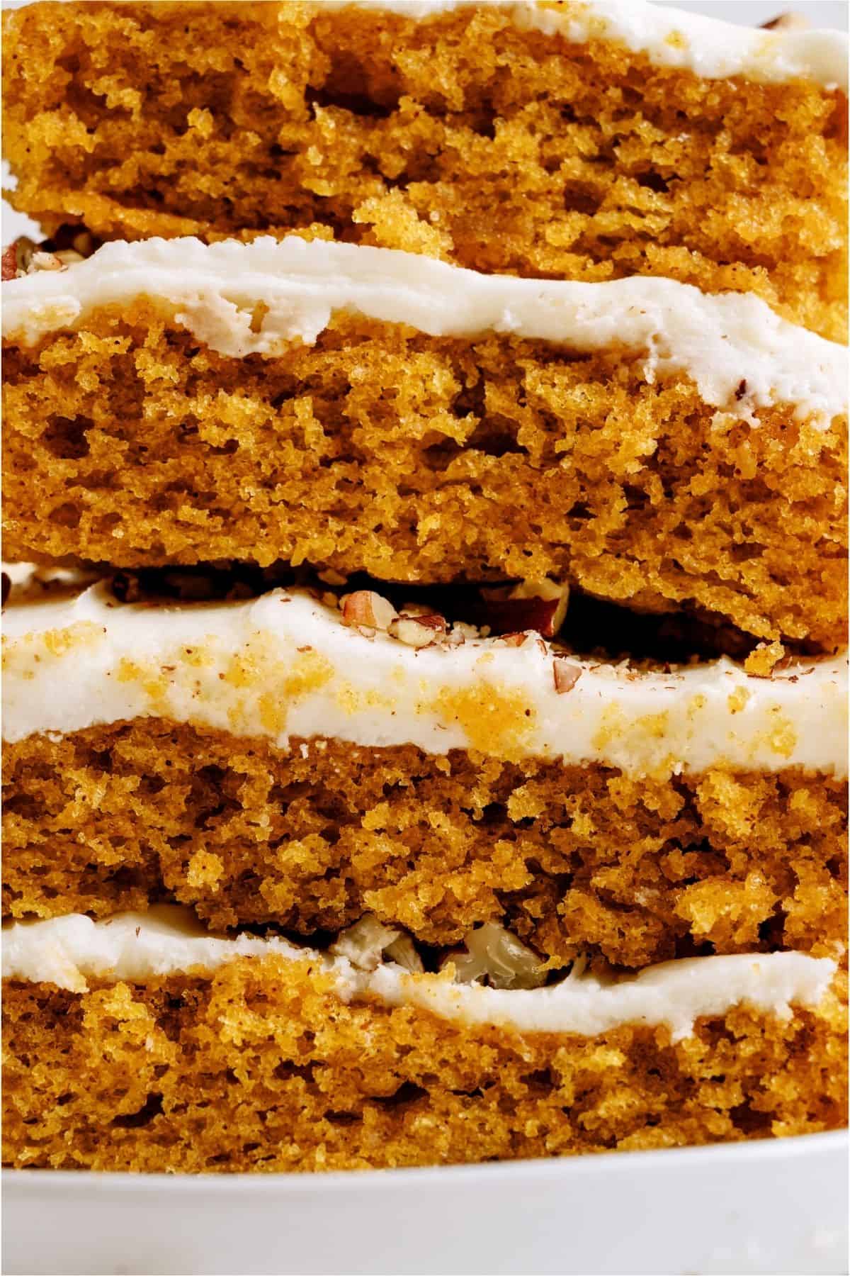 Sheet Pan Carrot Cake and Cream Cheese Frosting squares stacked on each other.