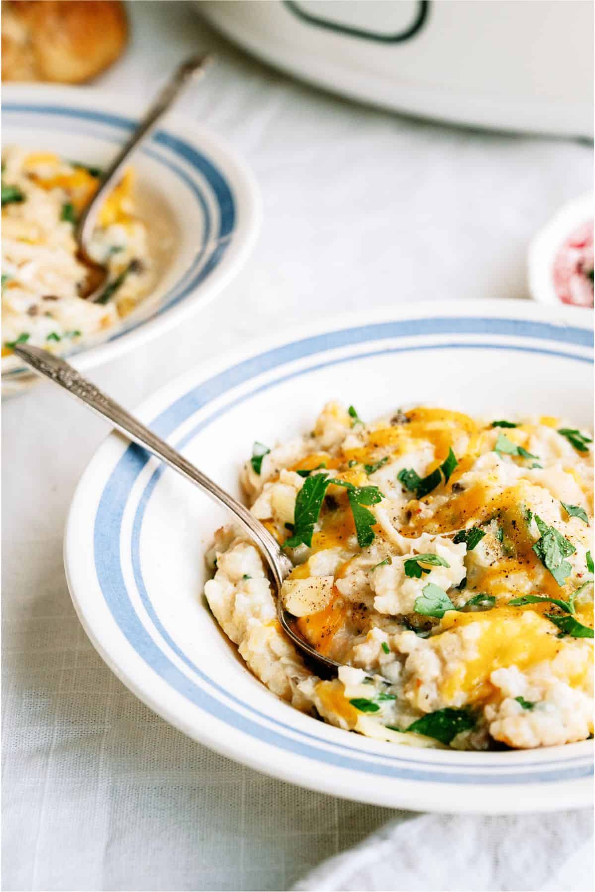 Two servings of Slow Cooker Parmesan Chicken And Rice in bowls