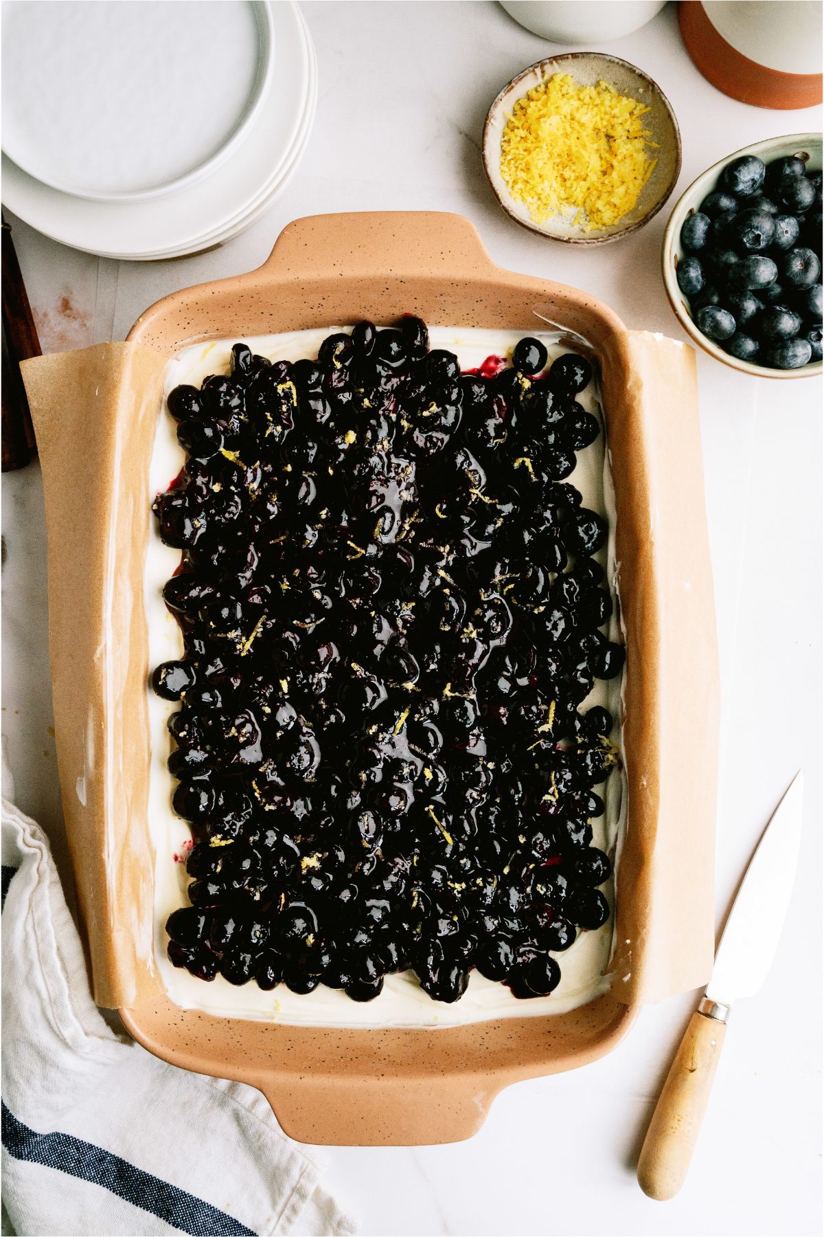 Blueberry Jamboree in a baking dish with lemon zest and blueberries on the side