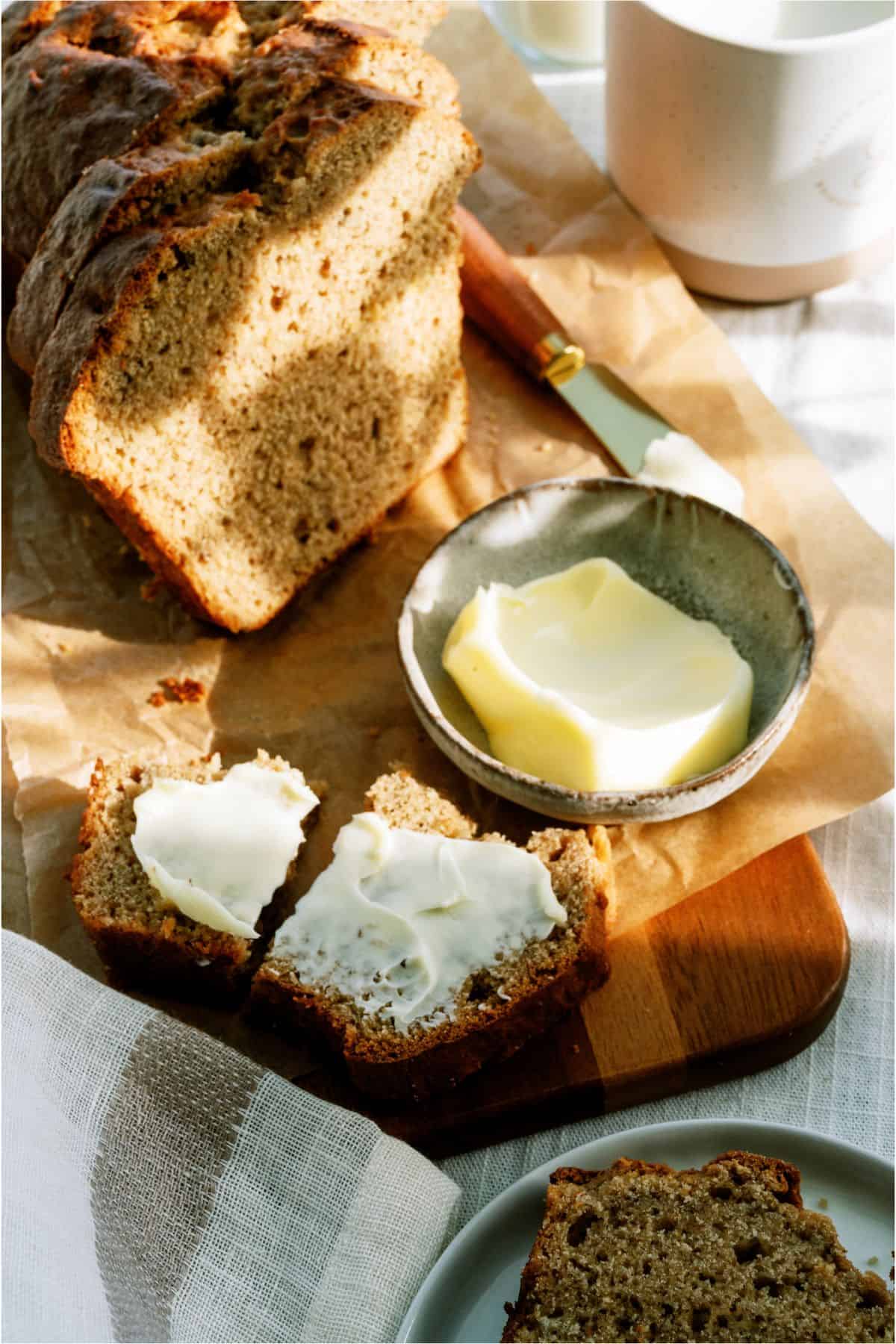 Brown Butter Banana Bread sliced with butter spread on one slice 