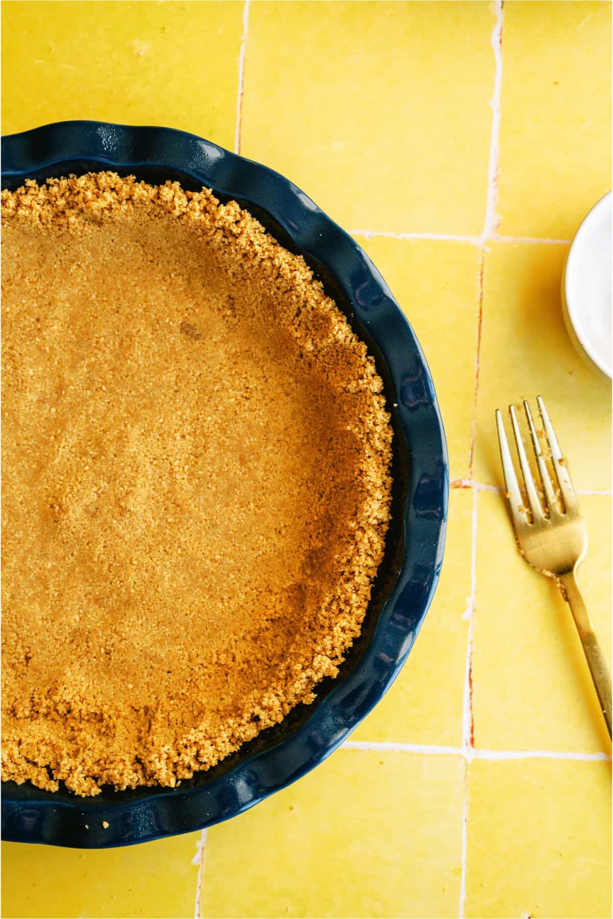 Graham cracker mixture pressed into pie plate to make pie crust.