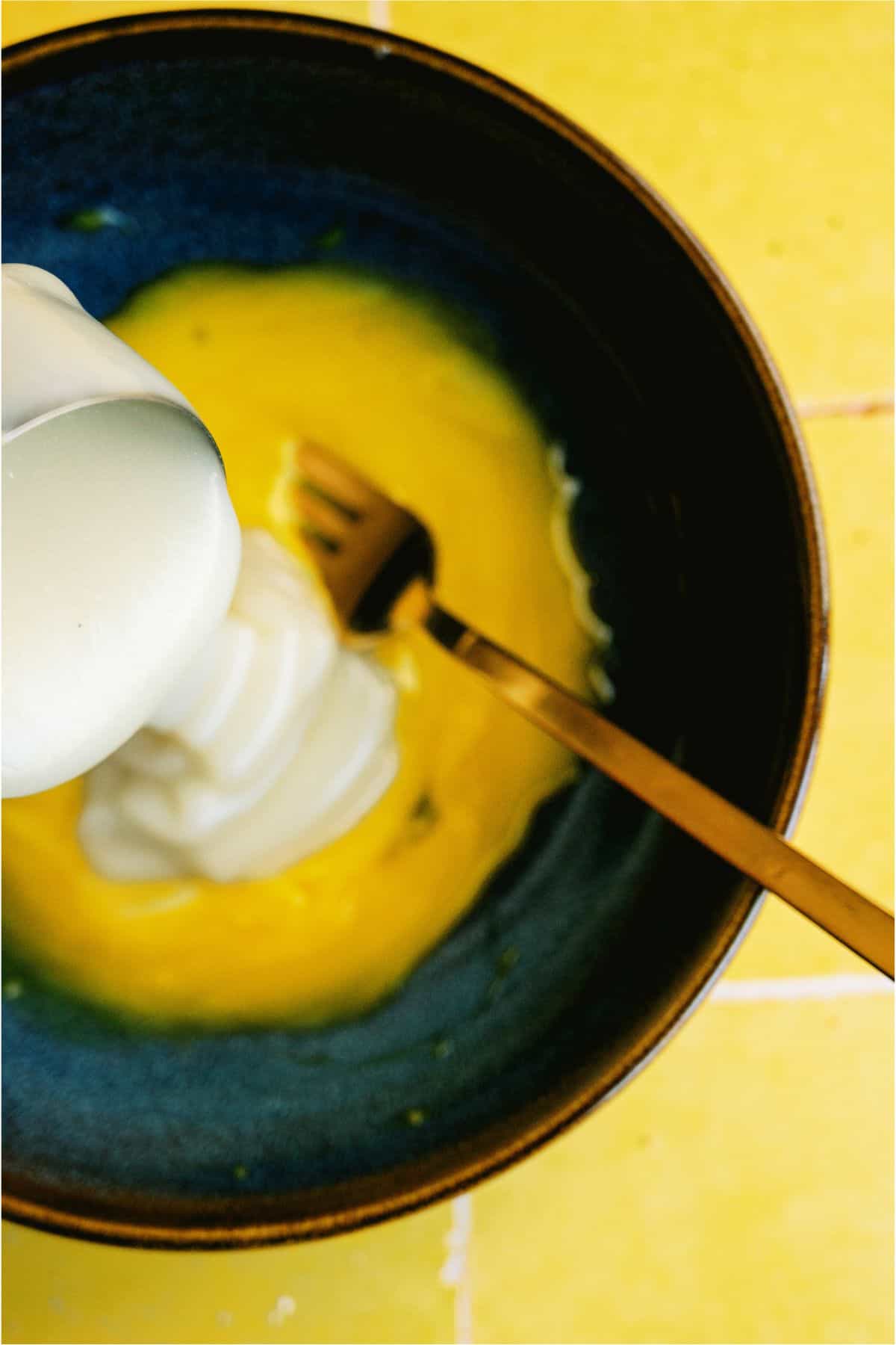 Adding milk in to saucepan to create lemon mixture