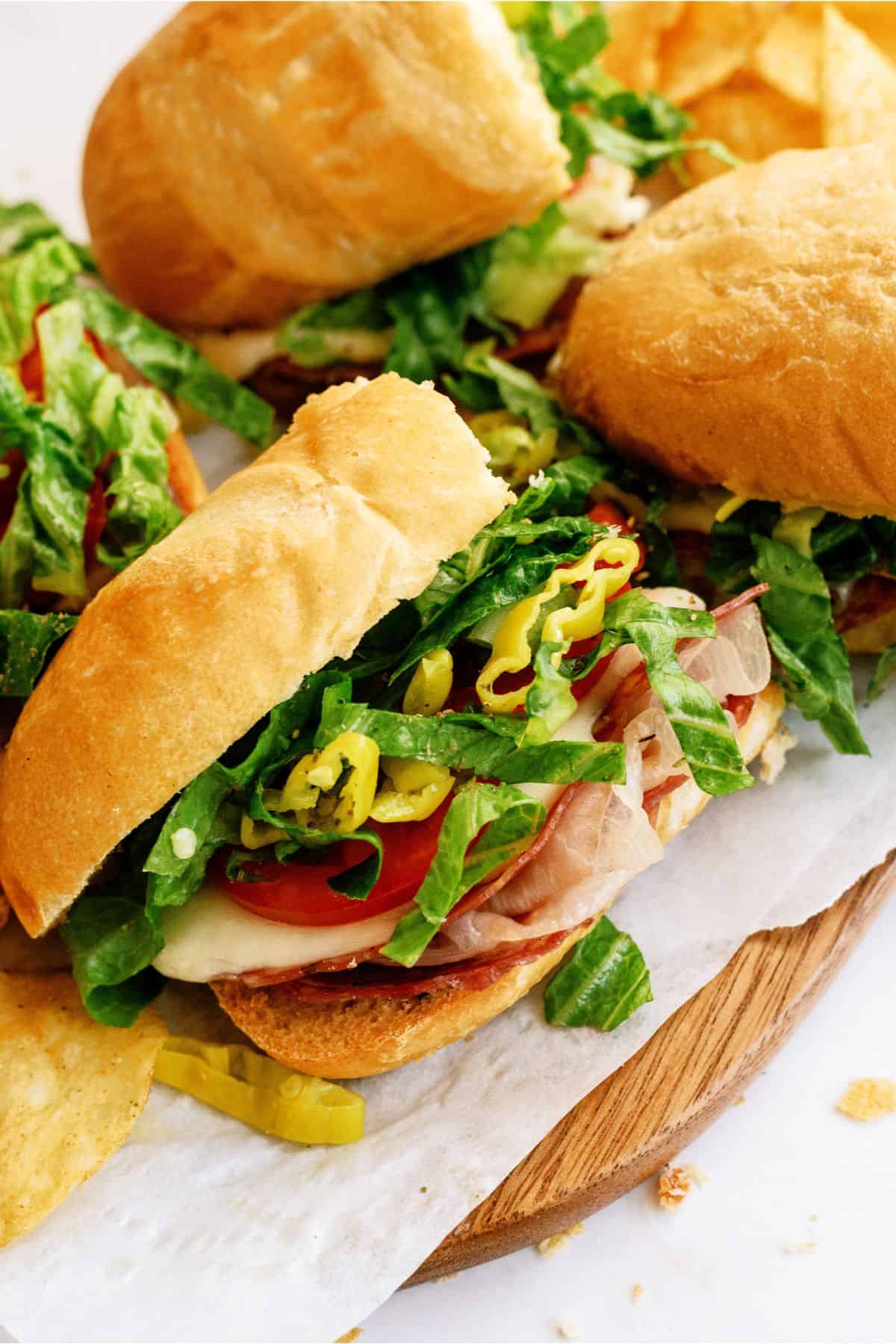 Top view of Hot Italian Trio Sandwiches on a cutting board