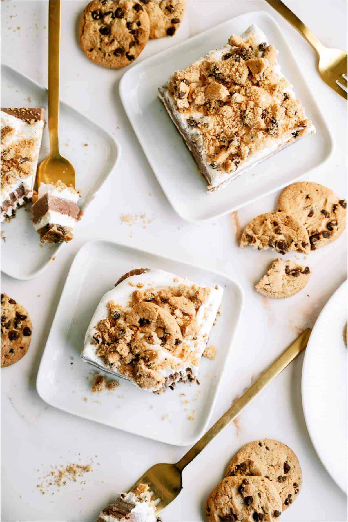 Slices of Layered Chocolate Chip Cookie Dessert on plates with forks