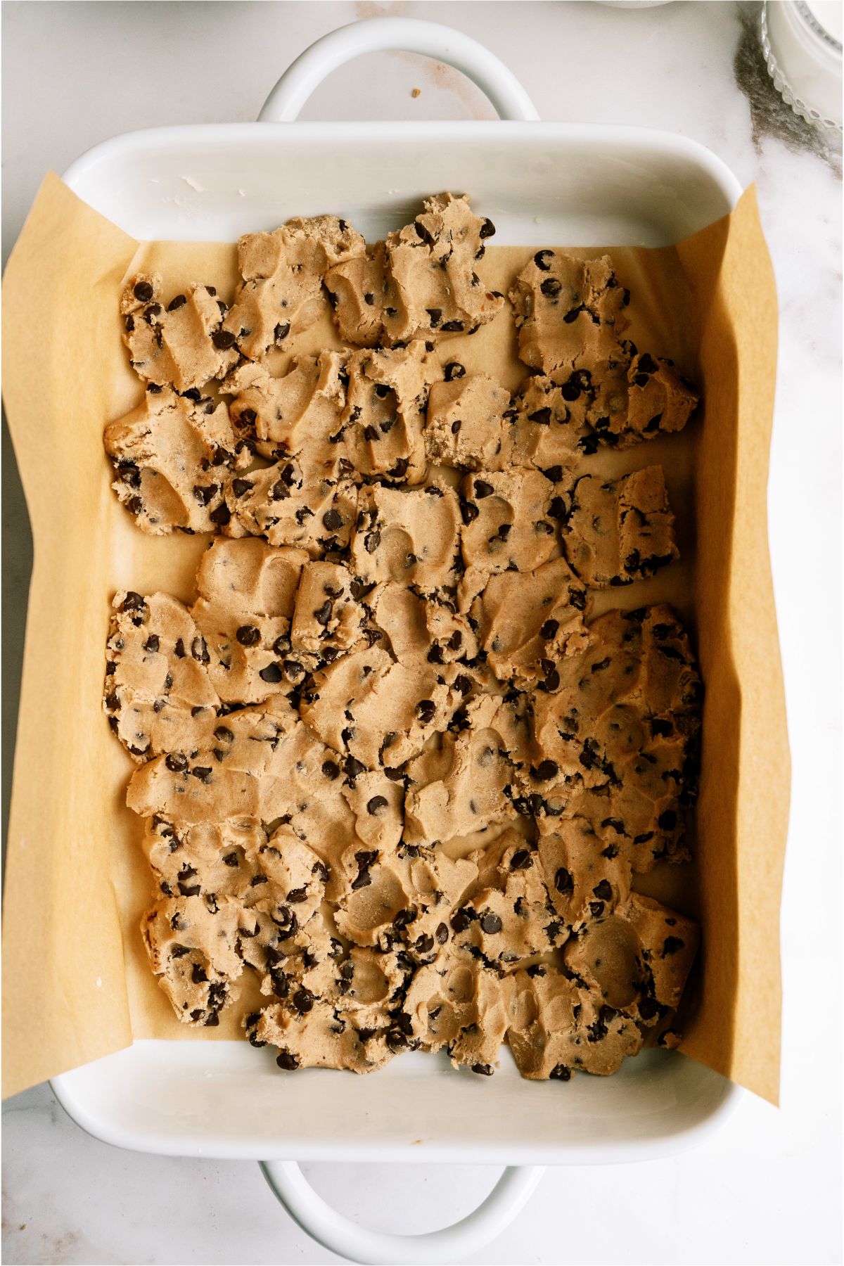 Cookie dough pressed into bottom of baking pan