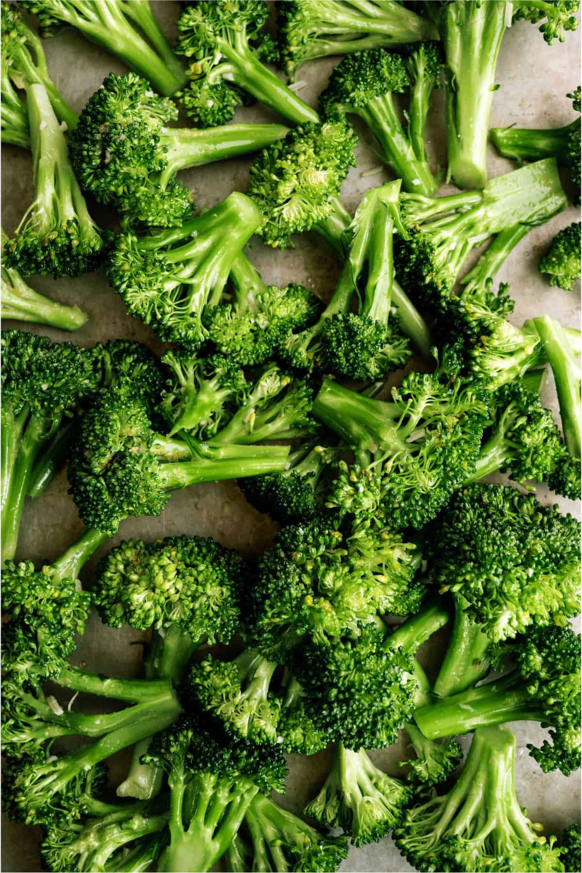 Broccoli spread out on a baking sheet