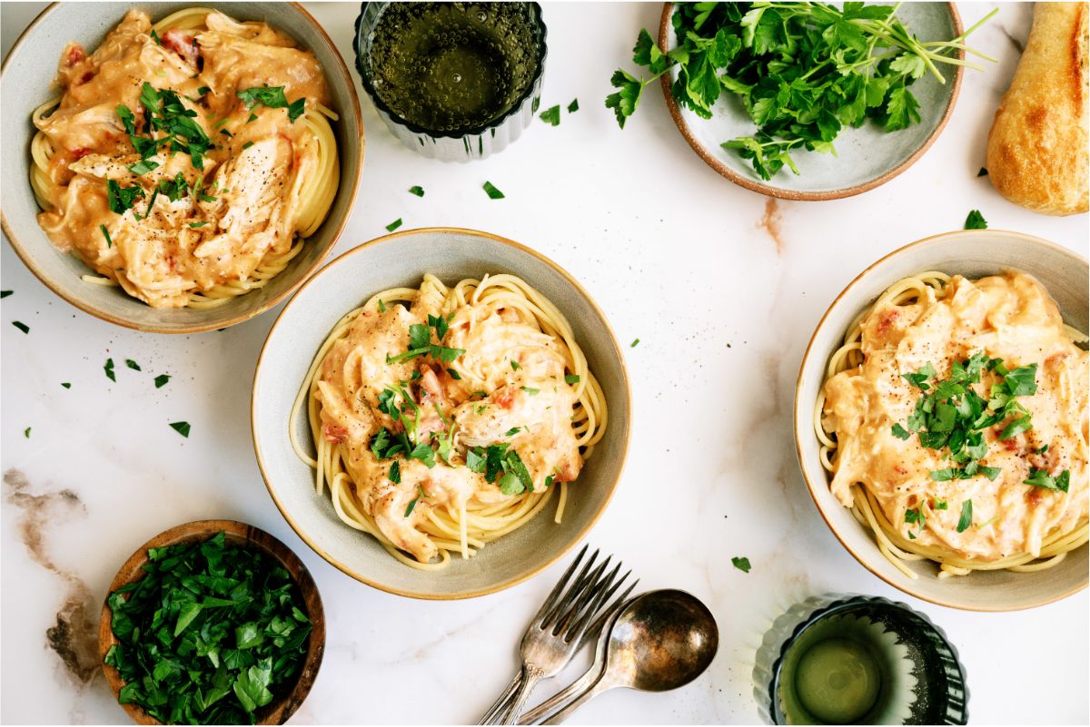 3 bowls of Slow Cooker Chicken Spaghetti with fresh parsley
