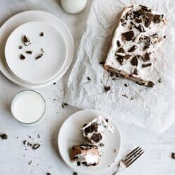 Oreo IceBox Cake on the counter with a slice on a plate