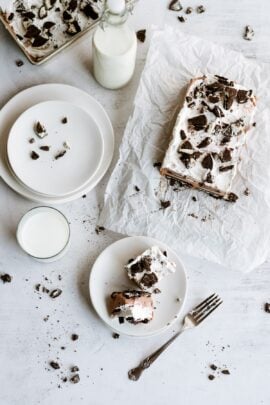 Oreo IceBox Cake on the counter with a slice on a plate