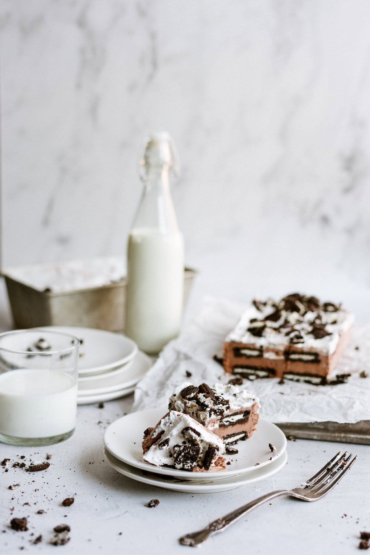 Close up of one slice of Oreo IceBox Cake on a plate with a fork