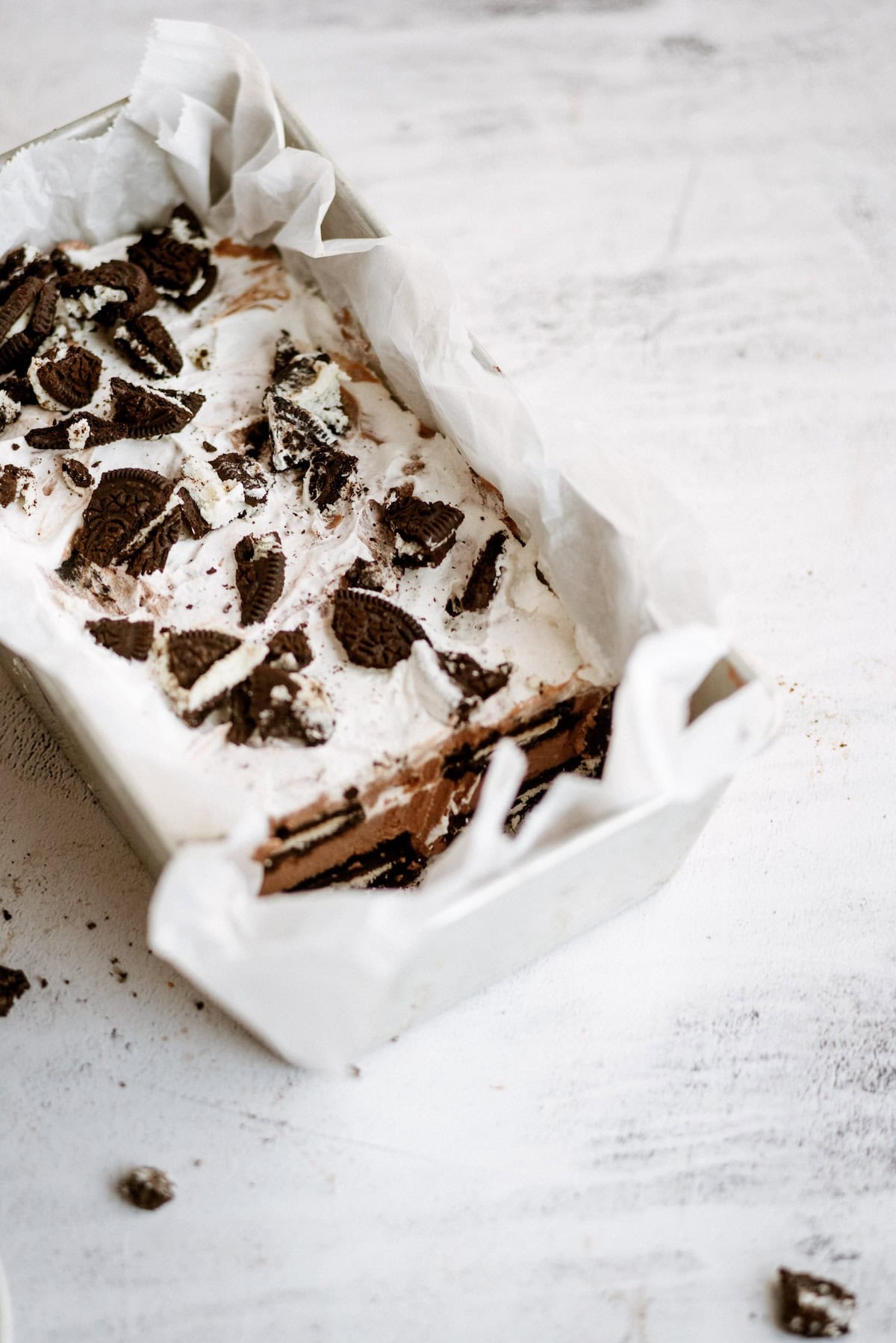 Oreo IceBox Cake on the counter inside loaf pan.