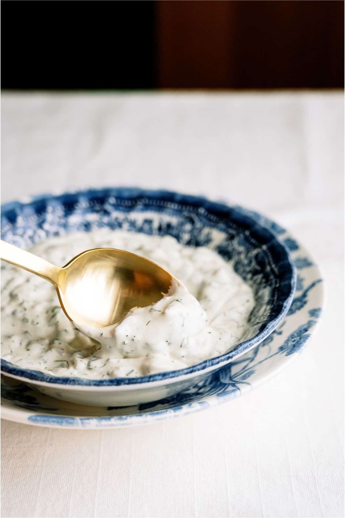 A bowl of Tartar Sauce with a serving spoon in it