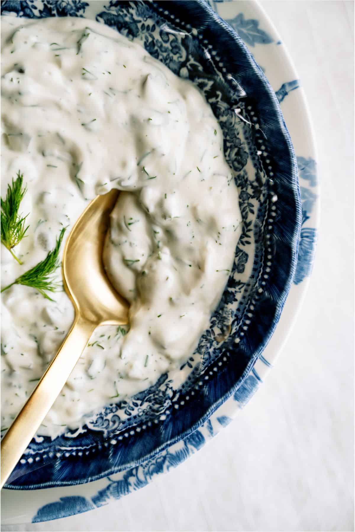 Top view of a bowl of Tartar Sauce with a serving spoon in it