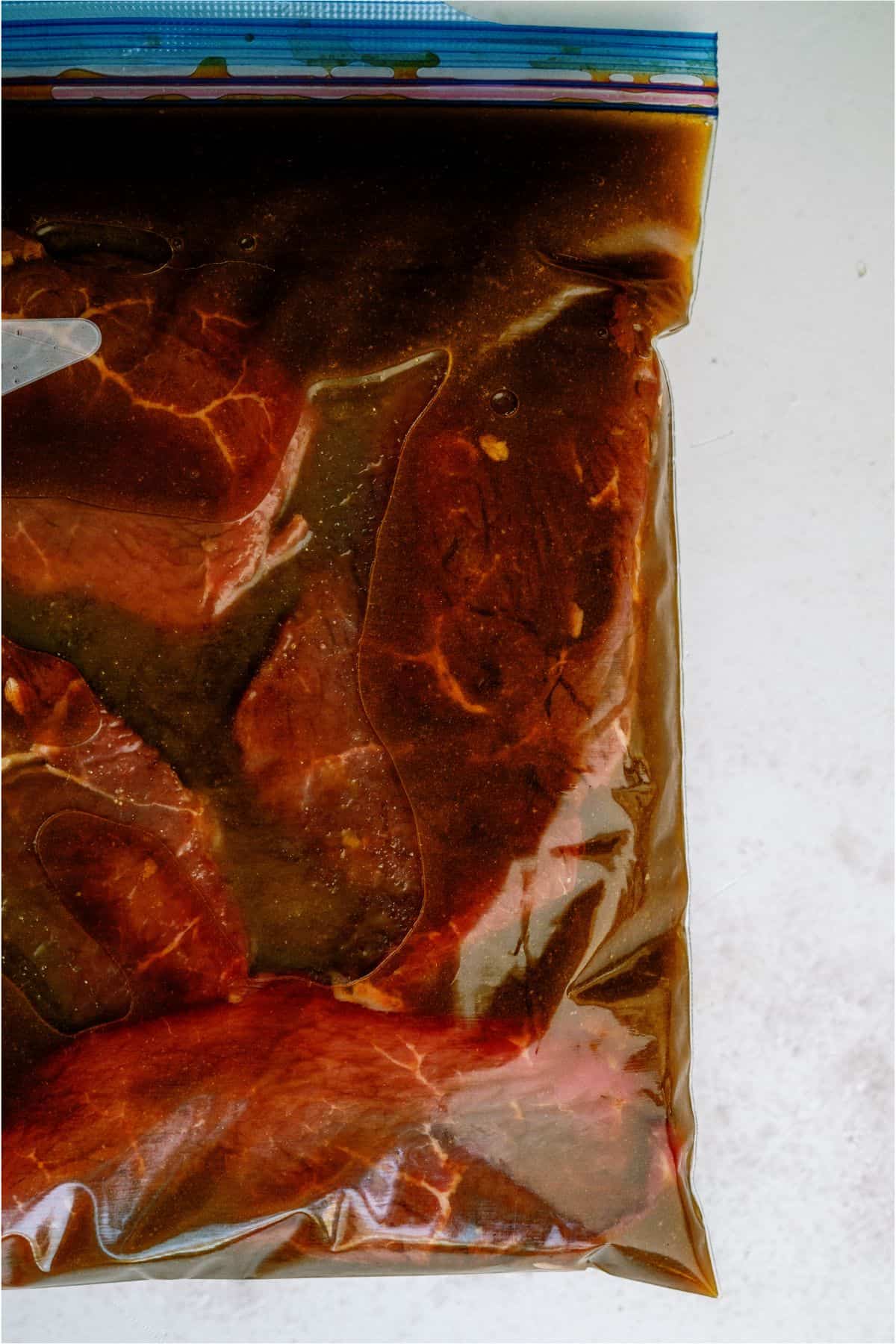 Steaks in a ziploc bag with Mom's Steak Marinade