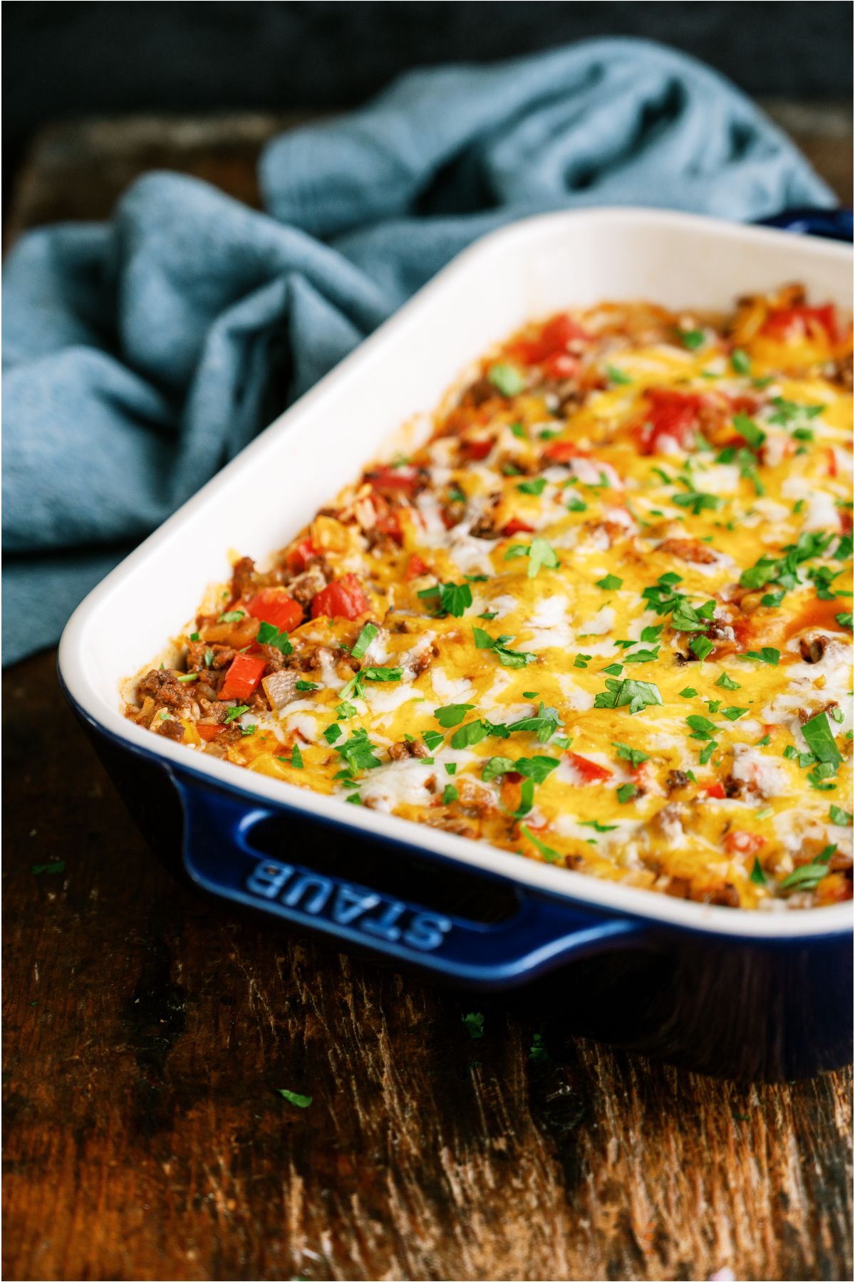 Baked Stuffed Pepper Casserole in a casserole dish next to a blue hand towel.