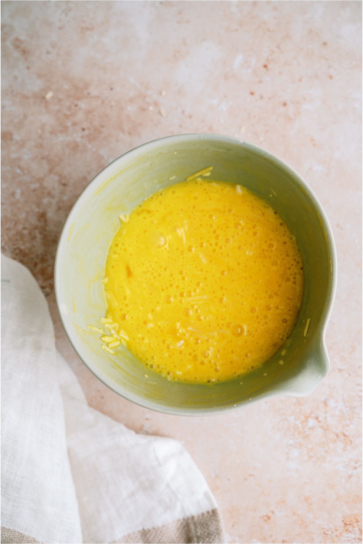 Parmesan egg mixture in a mixing bowl.