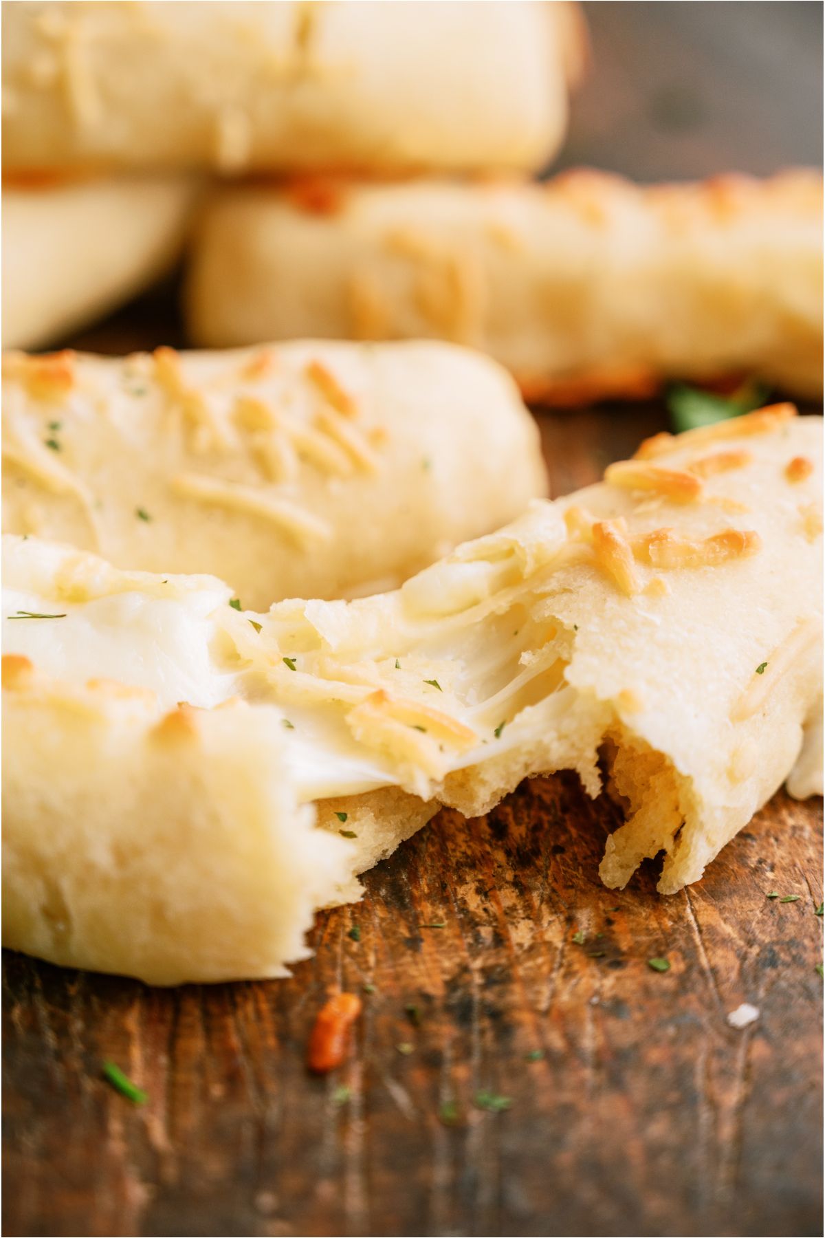 A Copycat Bosco Stick broke in half showing the melted cheese,