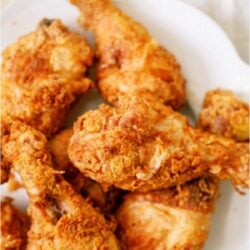 A plate of fried chicken on a table.