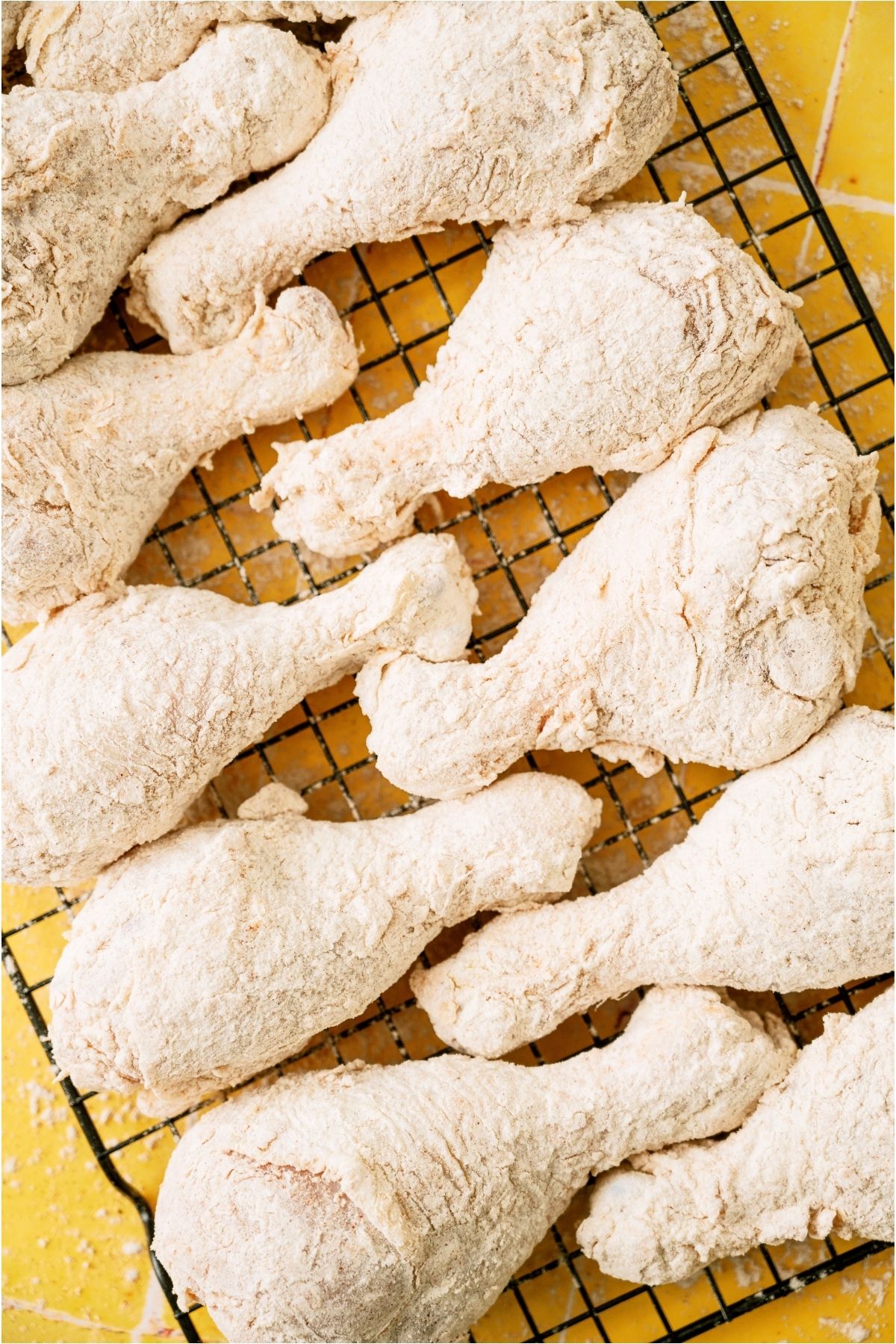 Breaded chicken pieces on top of a cooling rack.