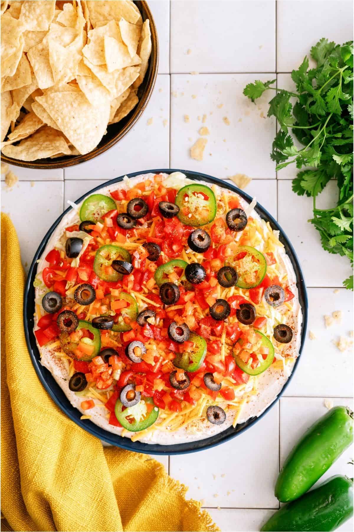 Easy Taco Dip platter with a side of chips.
