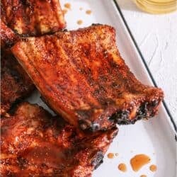 Grilled Baby Back Ribs on a white serving platter.