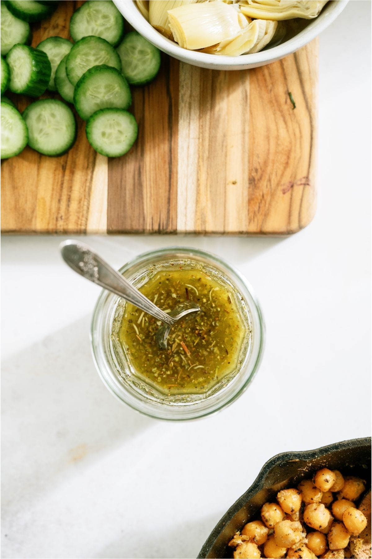 Homemade salad dressing in a cup with a spoon.