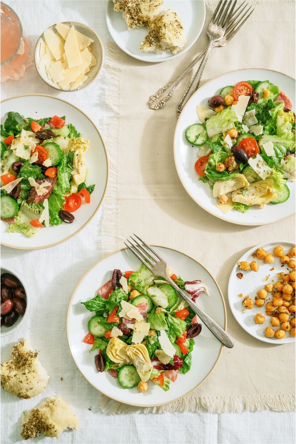 Italian Chopped Salad on three white plates with forks.