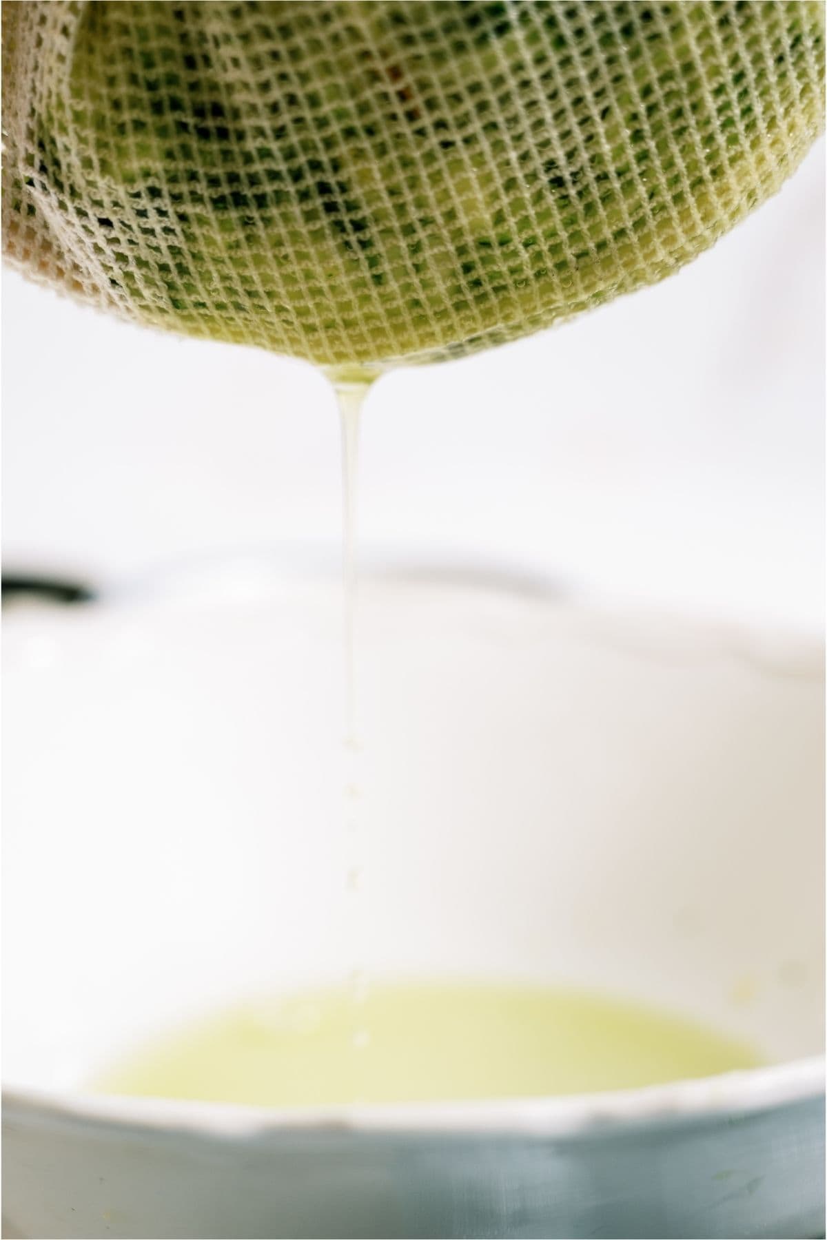 Draining excess moisture of zucchini with a cheesecloth.