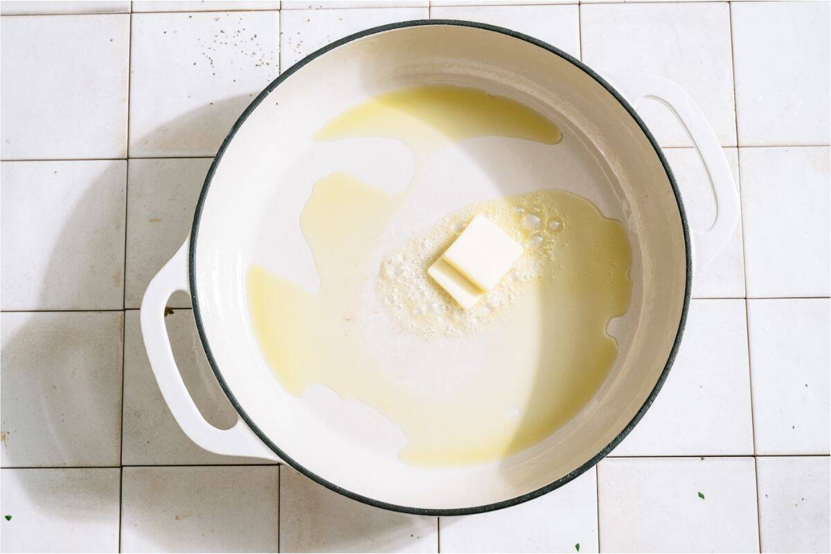Butter melting in a large skillet.