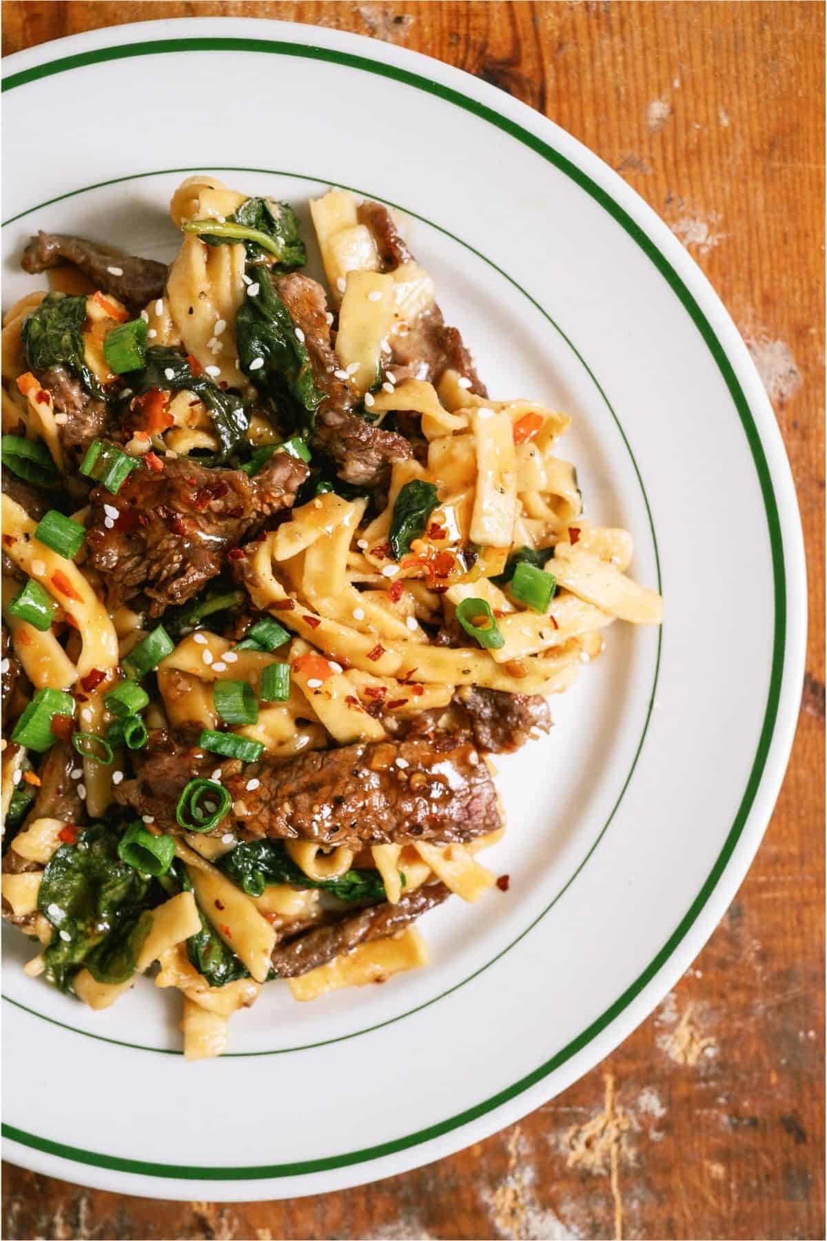 A serving of Beef and Noodles in a white bowl.