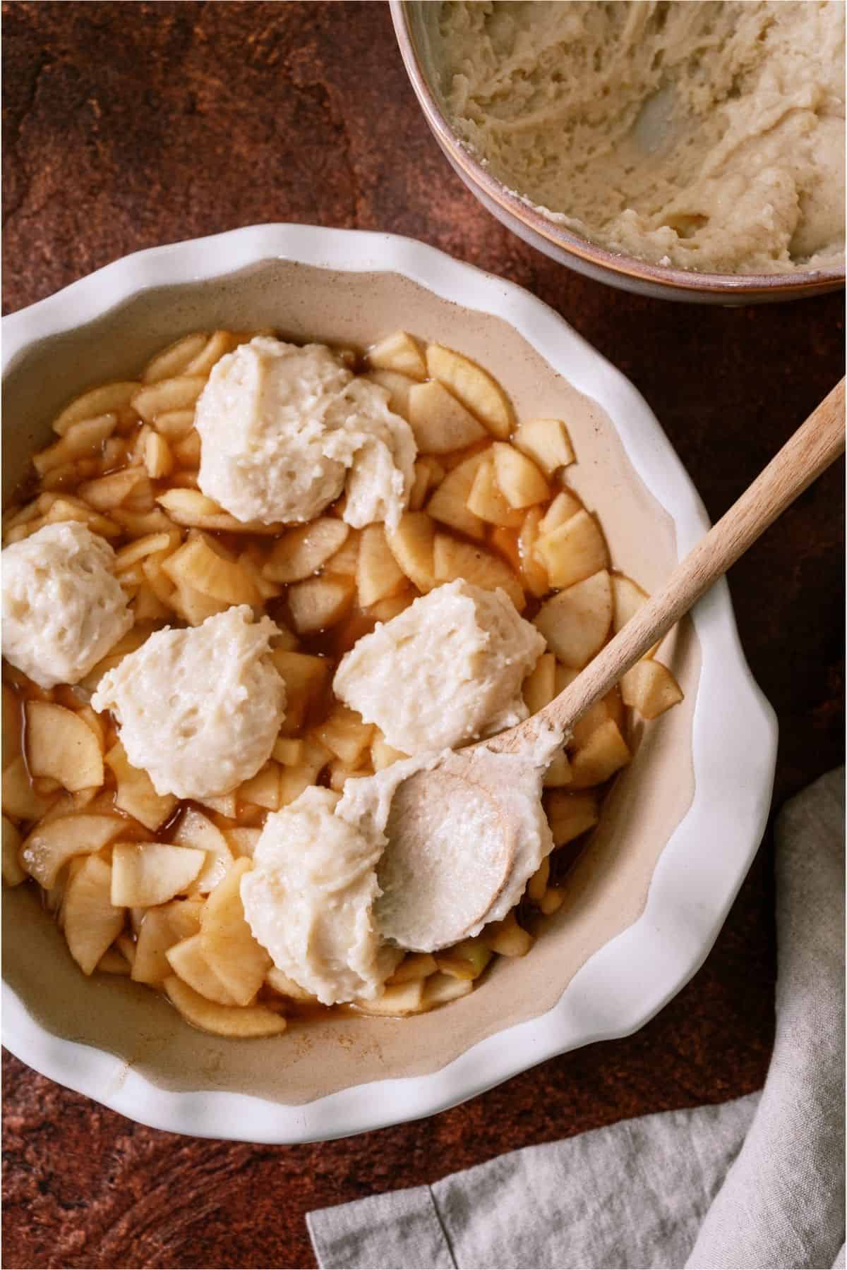 Flour topping in dollops on top of apple mixure.