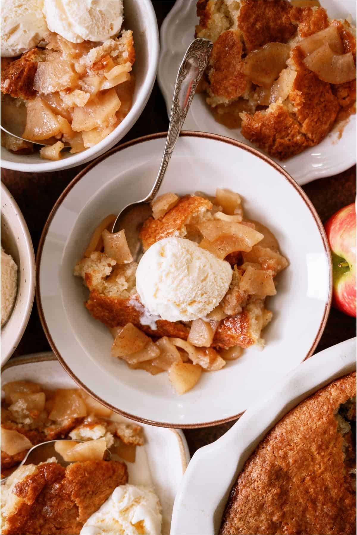 A serving of Easy Apple Cobbler in a bowl topped with a scoop of ice cream.