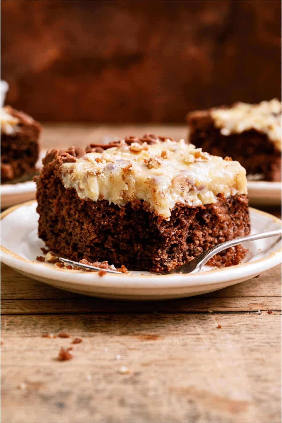 Slice of Homemade German Chocolate Cake on a plate with a fork.