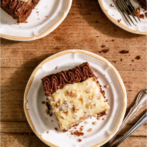 3 slices of Homemade German Chocolate Cake on plates with forks.