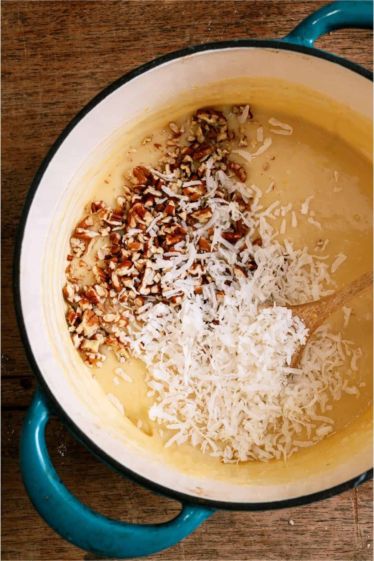 Ingredients for coconut pecan frosting in a saucepan.
