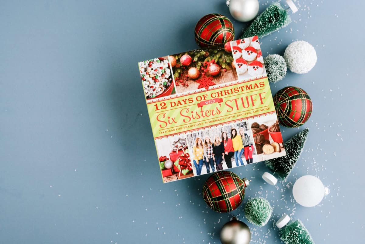 12 Days of Christmas Cookbook by Six Sisters' Stuff with ornaments and holiday decorations