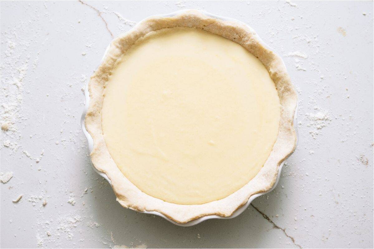 Unbaked Homemade Buttermilk Pie on a white background.
