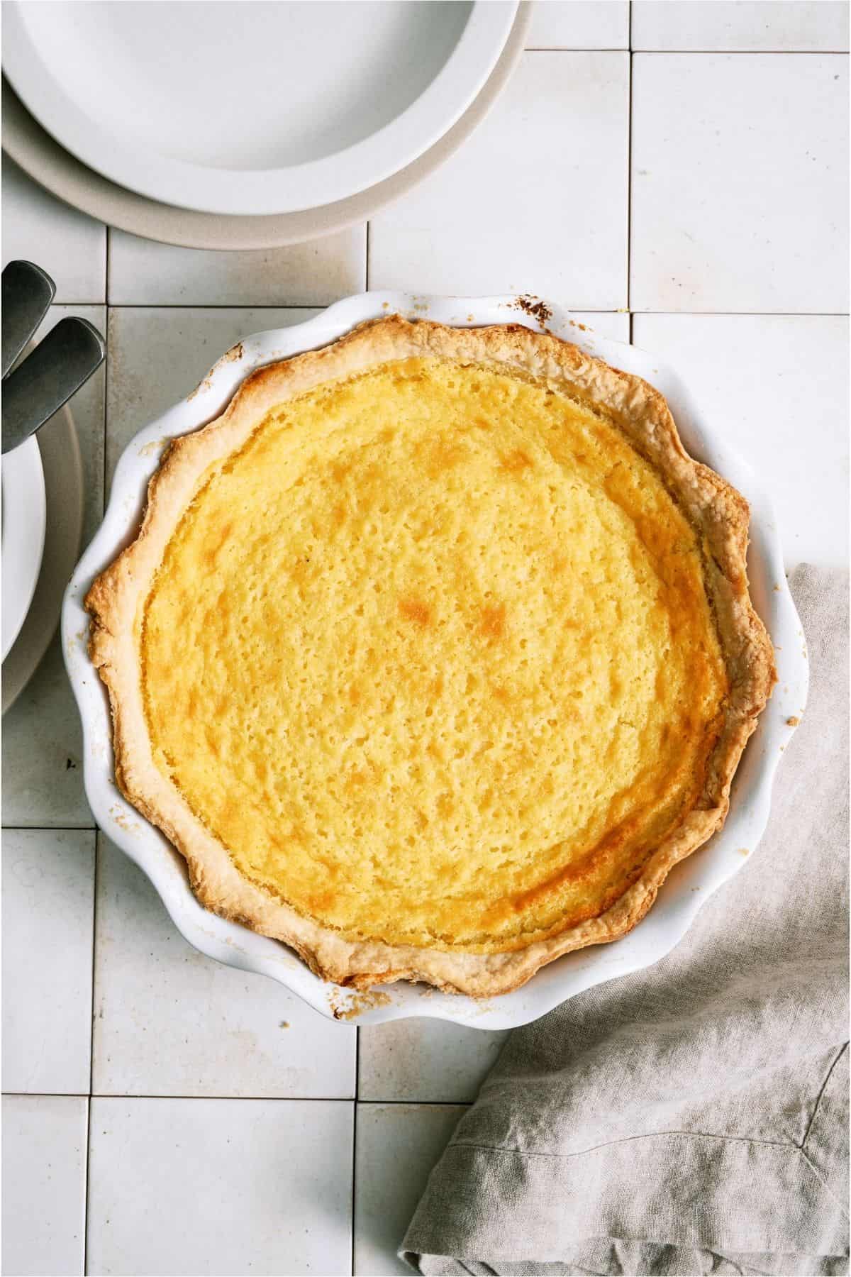 Top view of Homemade Buttermilk Pie in a white pie plate.