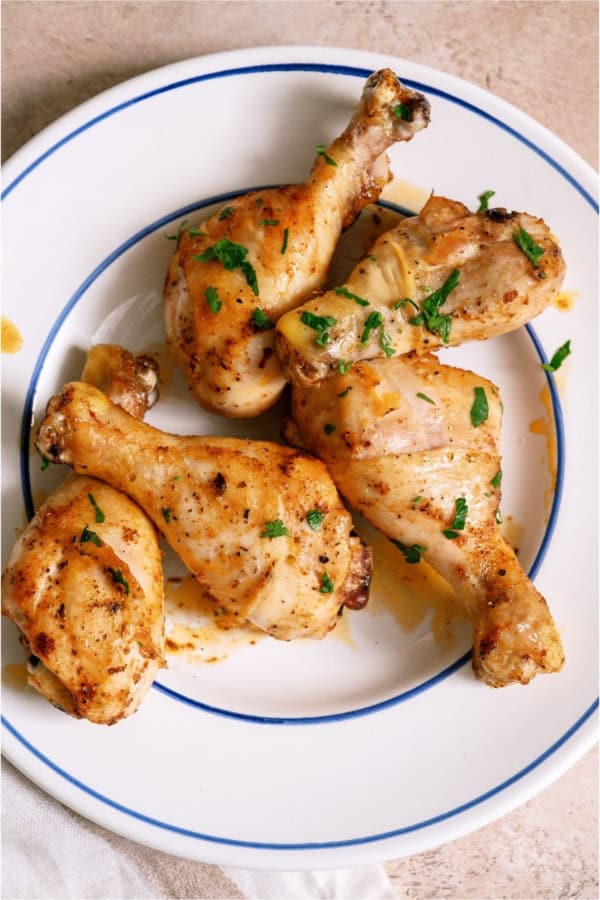 Top view of a plate of Juicy Baked Chicken Legs.