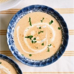 A bowl of Lobster Bisque topped with herbs.