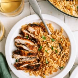 A serving of One Pot Chicken and Rice on a plate with a fork.